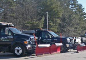 Commercial Snowplowing Services - Giant Landscaping Row of Giant Landscaping snowplow trucks