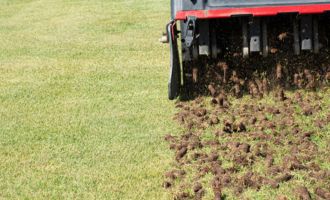 Core Aeration and Overseeding Closeup of lawn aerator machine