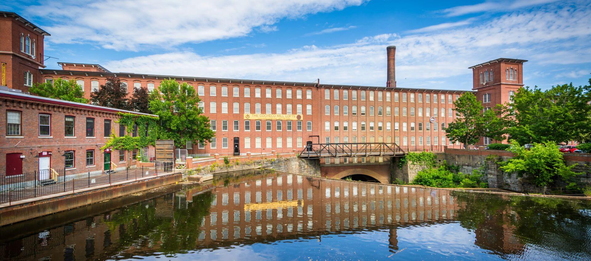 Long brick factory buildings on a canal river