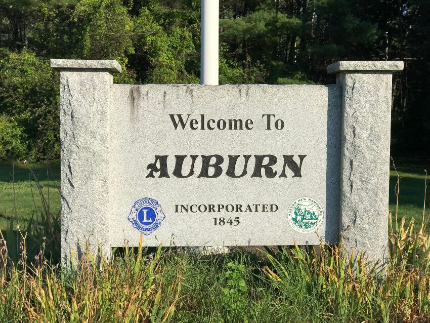 White granite sign with words Welcome to Auburn in black
