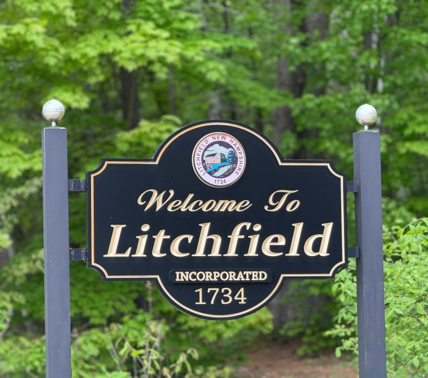Black wooden sign with words Welcome to Litchfield Incorporated 1734