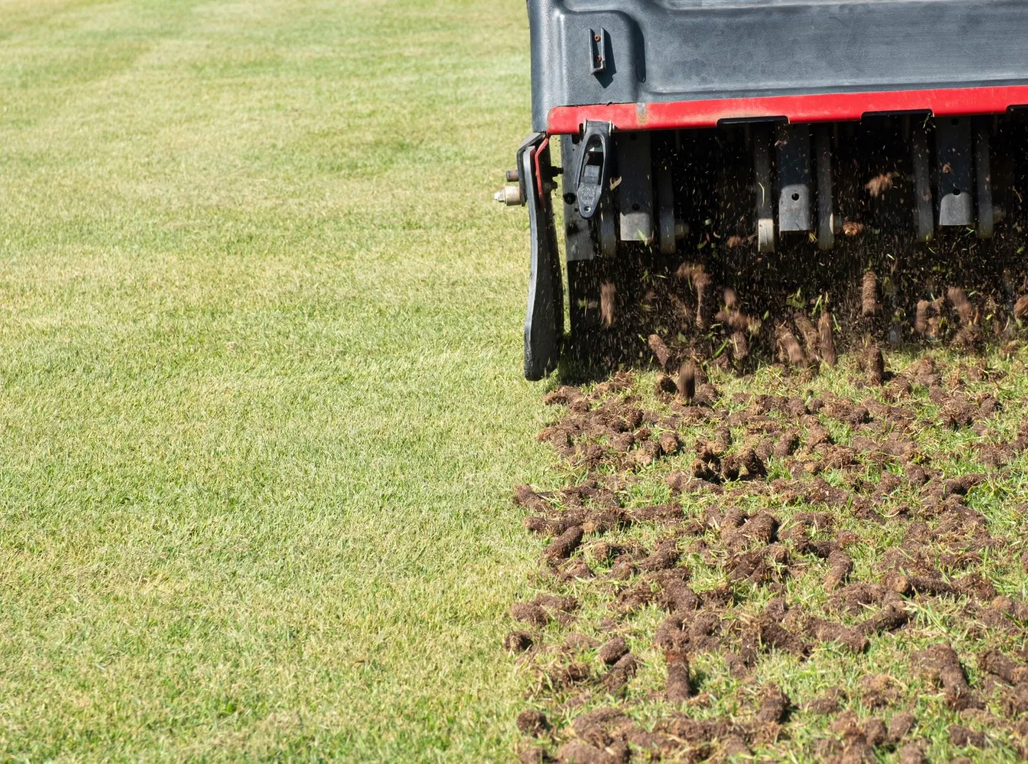 machine aerating a lawn